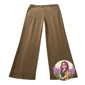 May include: A white ceramic mug with a black handle and the text "But First, Coffee" in a bold, black font. The mug is set against a blurred background, suggesting a cosy setting.