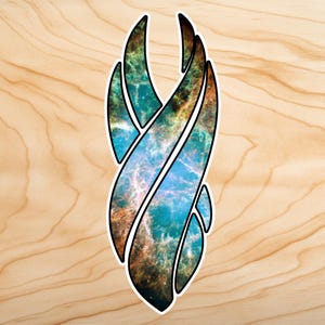 May include: A sticker featuring a stylized, abstract design with a black outline. The interior of the design showcases a vibrant nebula pattern in shades of blue, teal, orange, and brown, set against a light wood grain background.