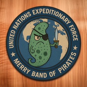 May include: A round, navy blue patch with the text "UNITED NATIONS EXPEDITIONARY FORCE" and "MERRY BAND OF PIRATES". The patch features a cartoon microbe with an eye patch holding a knife, set against a world map.