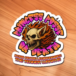 May include: A sticker featuring a skull with fiery orange hair and the text "Princess of Death" in a graffiti-style font. Additional text includes "103rd Recon Legionnaires" and "The Tenner Wraiths."