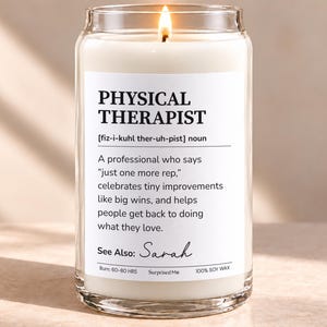 May include: A clear glass jar candle with white wax and a lit wick. The label features the text PHYSICAL THERAPIST, a phonetic pronunciation, a definition about helping people, the name Sarah, and the text 100% SOY WAX and Burn: 60-80 HRS.