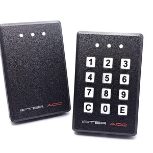 May include: Two black access control keypads with the text "IFTER ACC". One keypad has a numeric keypad with the numbers 1-9, C, 0, and E. Both keypads have three small white lights at the top.