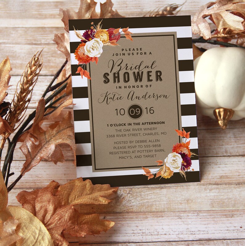 May include: A brown and black striped card with a fall-themed floral design. The card is an invitation to a bridal shower for Katie Anderson on October 9th, 2016 at The Oak River Winery in Charles, Missouri. The invitation includes the time, location, and RSVP information.