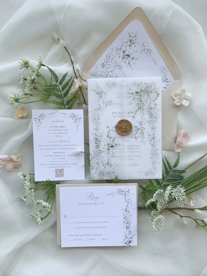 May include: A wedding invitation suite with a floral design. The invitation features a watercolor illustration of delicate white flowers and greenery. The RSVP card has a floral border and a space for guests to indicate their attendance. The text on the invitation reads "Penelope & Michael Smith" and the text on the RSVP card reads "RSVP kindly requested by May 1, 2023".
