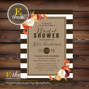 May include: A brown and white striped background with a kraft paper invitation for a bridal shower. The invitation features a floral design with fall colors and the text "Bridal Shower" in honor of Katie Anderson. The date is October 9, 2016, and the location is The Oak River Winery. The invitation also includes the address and RSVP information.