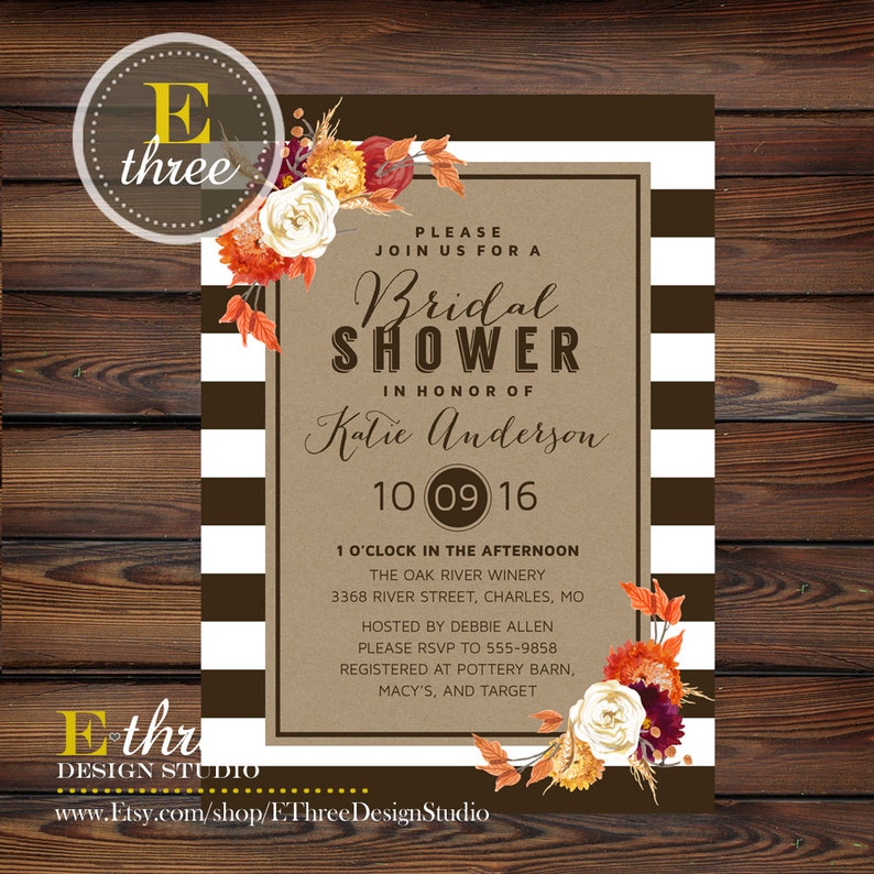 May include: A brown and white striped background with a kraft paper invitation for a bridal shower. The invitation features a floral design with fall colors and the text "Bridal Shower" in honor of Katie Anderson. The date is October 9, 2016, and the location is The Oak River Winery. The invitation also includes the address and RSVP information.