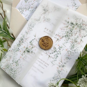 May include: A white wedding invitation with a floral design and a gold wax seal. The invitation reads "PENELOPE MICHELLE SMITH" and "FIFTH OF JUNE TWENTY-FIVE Afternoon CELLARS".