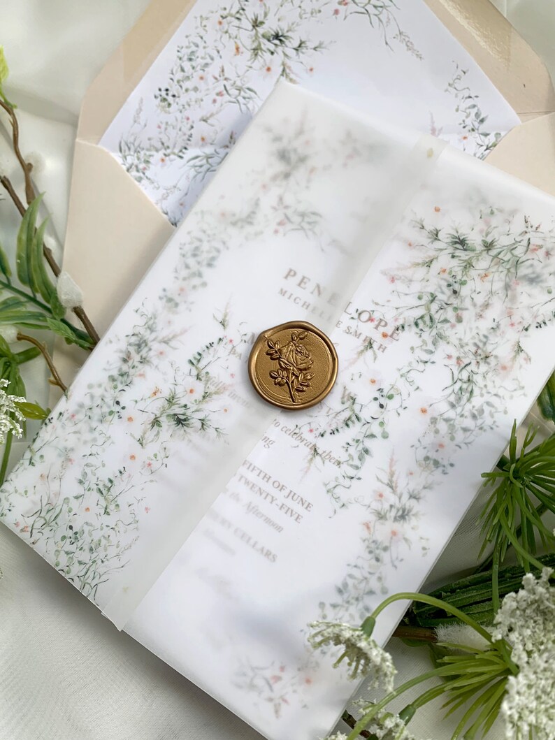 May include: A white wedding invitation with a floral design and a gold wax seal. The invitation reads "PENELOPE MICHELLE SMITH" and "FIFTH OF JUNE TWENTY-FIVE Afternoon CELLARS".