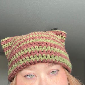 May include: A rustic wooden sign with the text "Welcome to our home" in white lettering. The sign features a distressed finish and a simple, inviting design, perfect for a front porch or entryway.