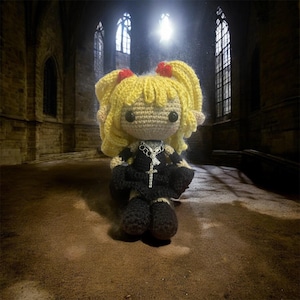 May include: Crocheted doll with blonde hair styled in pigtails, red bows, and black dress. The doll has a silver cross necklace and black boots. The background is a dimly lit gothic interior with arched windows.