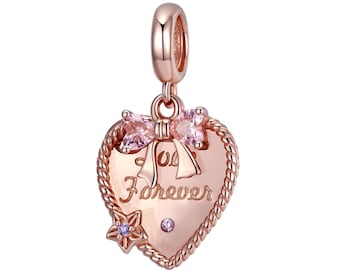 May include: Rose gold charm with a heart-shaped design featuring a bow and the inscription "You Forever". The charm has a rope-like border and is adorned with pink and clear cubic zirconia stones.