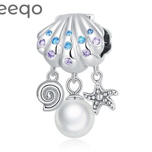May include: Silver charm featuring a seashell with purple and blue crystals, a pearl, a seashell, and a starfish.
