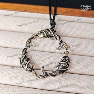 May include: A circular pendant featuring three metallic koi fish linked together in a continuous ring formation. The pendant has an antique brass finish with detailed scale textures and is suspended from a thin black cord. The text Player GOGOGO is visible.