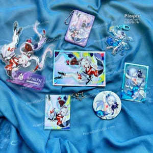 May include: A collection of anime-style character merchandise, including acrylic stands, keychains, a badge, and a card holder. The items feature colorful illustrations of a female character in dynamic poses, with a purple and white color scheme.