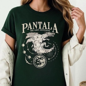 May include: Dark green t-shirt with the word "PANTALA" above a graphic of a map and a moon. The text "THE LOST CONTINENT" is below the word "PANTALA". The graphic is in a cream color.