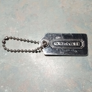 COACH Signature Silver Tone Brass Purse Hang Tag Fob Keychain CharmCharm. 4&quot; x 1&quot;