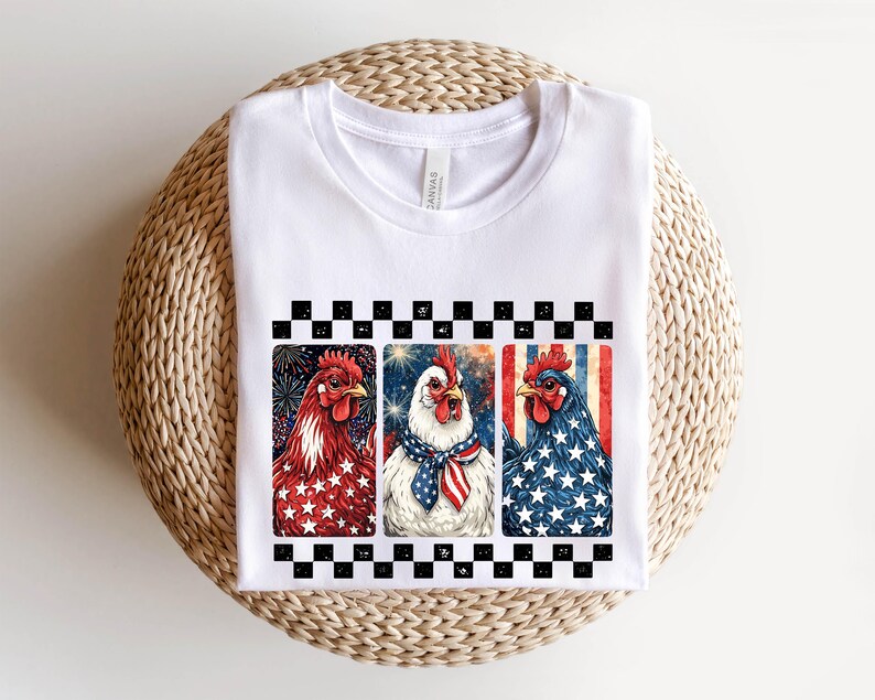 May include: White t-shirt featuring three rooster illustrations with patriotic themes. The roosters are depicted in red, white, and blue, with star and stripe patterns. The design is framed by a black and white checkered border.
