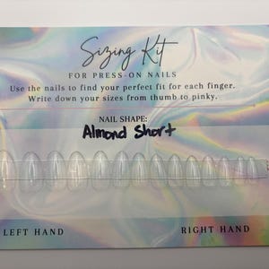 May include: A press-on nail sizing kit with clear, almond-shaped nails. The card reads "Sizing Kit for Press-On Nails" and instructs users to find their perfect fit. The nail shape is labeled "Almond Short."