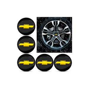 May include: Black wheel center caps with a yellow bowtie logo. The image also shows a car wheel with a silver and black design. The words "hand made" are in the top left corner.