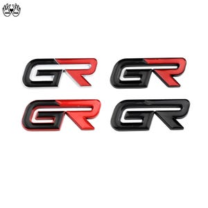 May include: Four GR emblems arranged in a grid. The top left and bottom left emblems feature a black G and a red R with a white outline. The top right emblem has a black G and a red R. The bottom right emblem is entirely black.