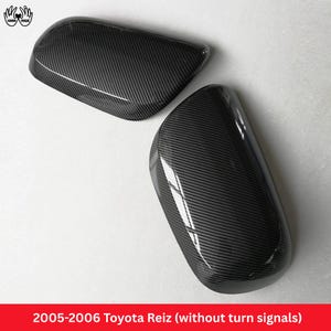 May include: Two black carbon fiber pattern side mirror covers for a 2005-2006 Toyota Reiz without turn signals. The covers have a glossy finish and a diagonal weave texture, designed to fit the exterior side mirrors of the vehicle.