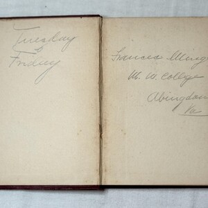 May include: An open vintage book with handwritten text. The left page has "Tuesday" and "Friday" written in cursive. The right page has a name, college, and location written in cursive.