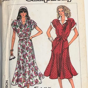 May include: Vintage Simplicity sewing pattern 8009. The pattern features illustrations of two dresses: one with a floral print and the other with a polka dot design. The text "E-A-S-Y TO SEW" is visible.