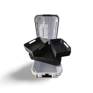 May include: An open, white and black storage case with three black trays. The case has a white interior and a black rim. The trays are rectangular with handles. The case is designed to hold items.