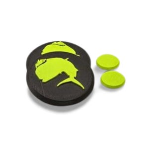 May include: Black and neon green fishing-themed patches. Two black, round patches with a neon green fish design are stacked. Two smaller, neon green, round patches are to the right. The patches are likely made of rubber or a similar material.