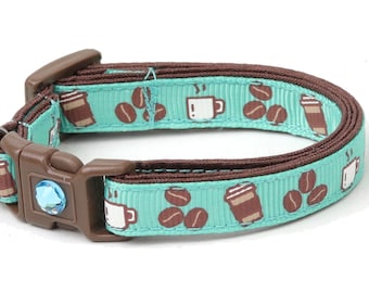 May include: A turquoise blue cat collar with a brown trim and a pattern of coffee cups and coffee beans. The collar has a bell attached to it.