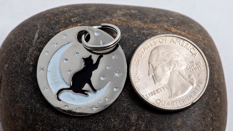 tag next to a US quarter for scale. The tag is slightly wider than the quarter.