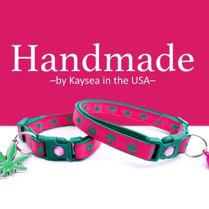 May include: Two handmade cat collars with a pink and green color scheme. The collars feature a green leaf pattern and a pink jewel. One collar has a green leaf charm, and the other has a pink bell.