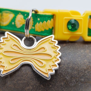 Pasta pet tag shown on an example collar. The collar is green with pasta shapes, and is not included with the tag.