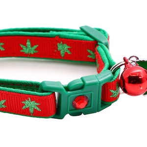 May include: Red and green cat collar with a green marijuana leaf pattern and a red bell with a green marijuana leaf charm.