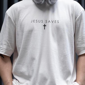 Jesus Saves Shirt with Cross Minimalist Typography Design png-Jesus Christian png-God Religious Bible Verse Faith Scripture Graphic Tee png