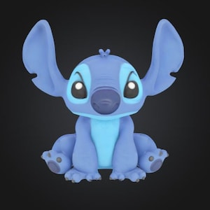 May include: A blue cartoon character with large ears, a dark blue nose, and big eyes. The character is sitting with its arms and legs spread out. The character's fur is a light blue color, with darker blue accents around the eyes and on the ears.