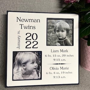 May include: A white wooden picture frame with two black and white photos of twins. The frame has the text "Newman Twins" and "January 30, 2022". The text below the photos includes the twins' names, birth weights, lengths, and times of birth.