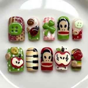 May include: A white ceramic mug with a black handle and the text "But First, Coffee" in a black, bold font. The mug is on a white surface.