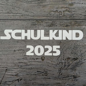 May include: White text on a gray, weathered wood background. The text reads "SCHULKIND 2025". The design is simple and modern, with a focus on the message. The wood grain adds texture and visual interest.