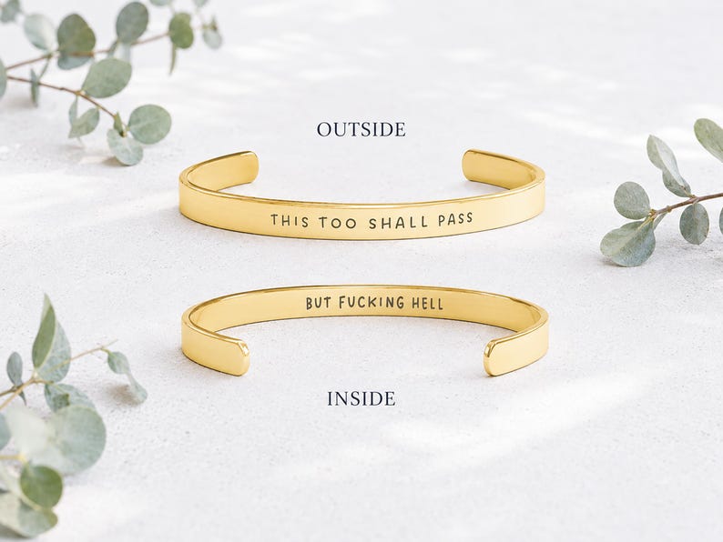 Gold stainless steel cuff bracelet with outside engraving This Too Shall Pass and inside engraving But Fucking Hell