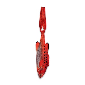 May include: A necktie featuring a realistic fish print with a vibrant red base color, dark grey scales, and black spots. The tie has a long, narrow shape that tapers toward the top, ending in a loop for wearing around the neck, with fins visible.