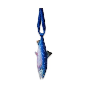 May include: A necktie featuring a realistic print of a blue trout fish with white spots and a silver-toned head. The fabric is a deep blue shade with a subtle sheen, and the tie is shaped to mimic the elongated, tapered body of a freshwater fish.
