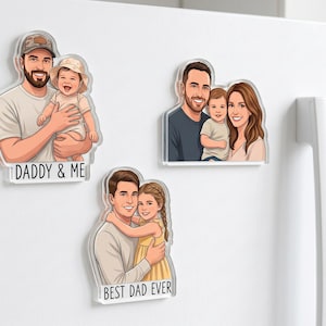 May include: Three clear acrylic magnets with cartoon illustrations of families. One magnet reads "DADDY & ME" and features a father and child. Another shows a family of three. The last magnet says "BEST DAD EVER" with a father and daughter.