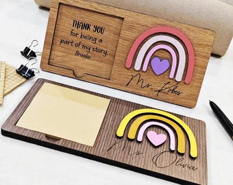 May include: Wooden desk organizers with rainbow and heart designs. One has a photo frame with the text "THANK YOU for being a part of my story. Brooke." The other has a sticky note pad and the name "Mrs. Olivia."