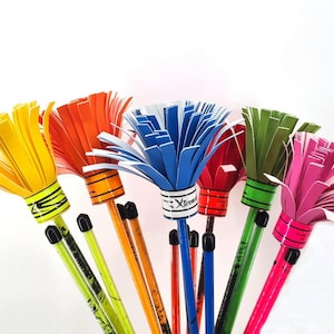 May include: A collection of colorful, handmade pencils with paper flower-like tops. The pencils feature vibrant hues of yellow, orange, blue, red, green, and pink. Each pencil has a black tip and a decorative band near the top.