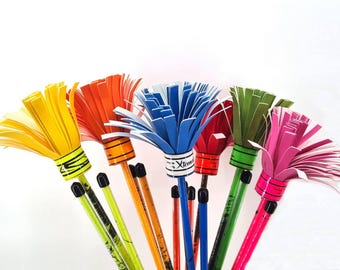 May include: A selection of brightly coloured pencils, each topped with a paper flower design. The pencils display a range of colours including yellow, orange, blue, red, green, and pink. Each pencil has a black tip and a decorative band.