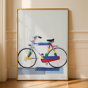 May include: A framed art print of a colorful bicycle. The bicycle is depicted with a variety of colors, including red, yellow, blue, and green. The artwork is framed in a gold-colored frame and is leaning against a wall.