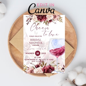 Puede incluir: Invitación a una despedida de soltera con detalles florales y una ilustración de copa de vino. La invitación incluye el texto "Cheers to love" y detalles del evento. El diseño presenta rosas burdeos y crema.