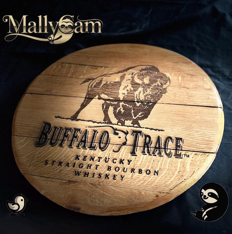 May include: A circular wooden sign displaying the Buffalo Trace logo, with a bison illustration and text. The sign is made of light brown wood and has the words "Kentucky Straight Bourbon Whiskey" engraved on it.