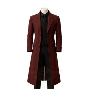 May include: A burgundy overcoat with a matching vest, black shirt, tie, and trousers. The long coat has a classic design with a notched lapel and button closure. The outfit is displayed on a mannequin.